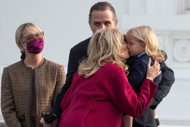 First lady Jill Biden kisses her grandson Beau Biden as his father Hunter Biden holds him with wife Melissa Cohen at arrival of the 2021 Christmas Tree at the White House in Washington, DC, on Nov. 22, 2021.